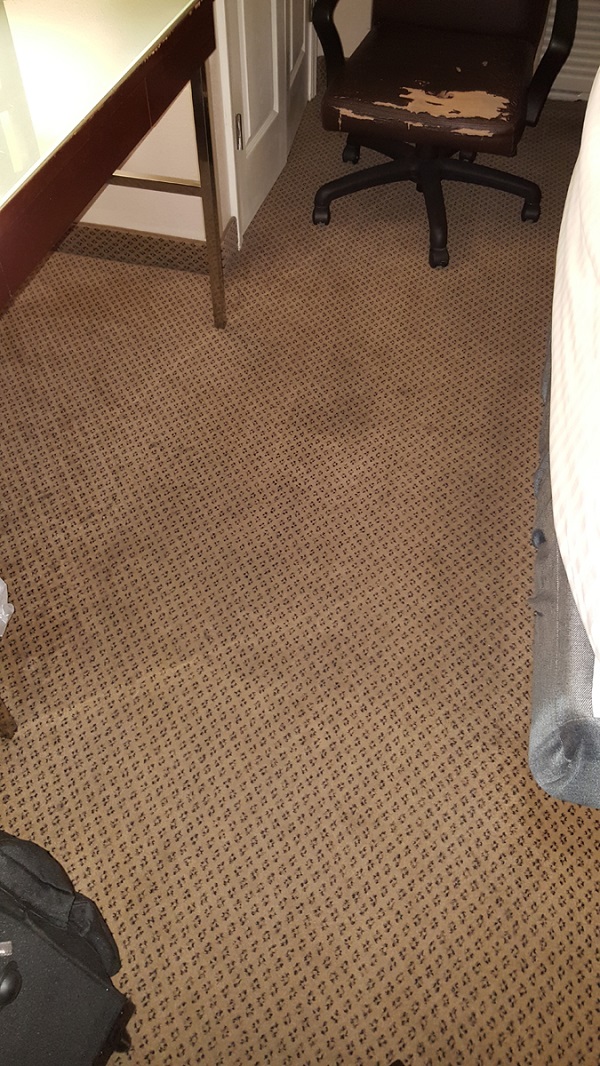 Dirty carpet in a hotel room